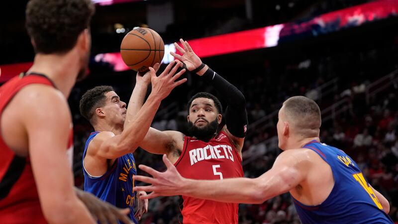 Houston Rockets' Fred VanVleet (5) passes the ball as Denver Nuggets' Michael Porter Jr. (1)...