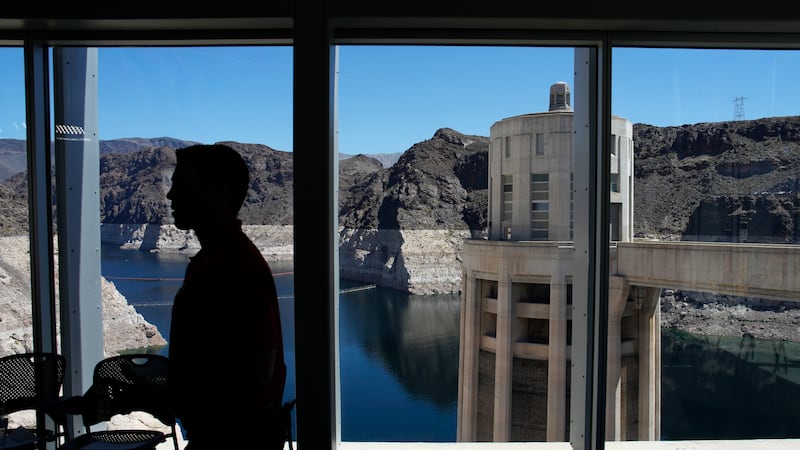 FILE - People attend a news conference on Lake Mead at Hoover Dam, April 11, 2023, near...
