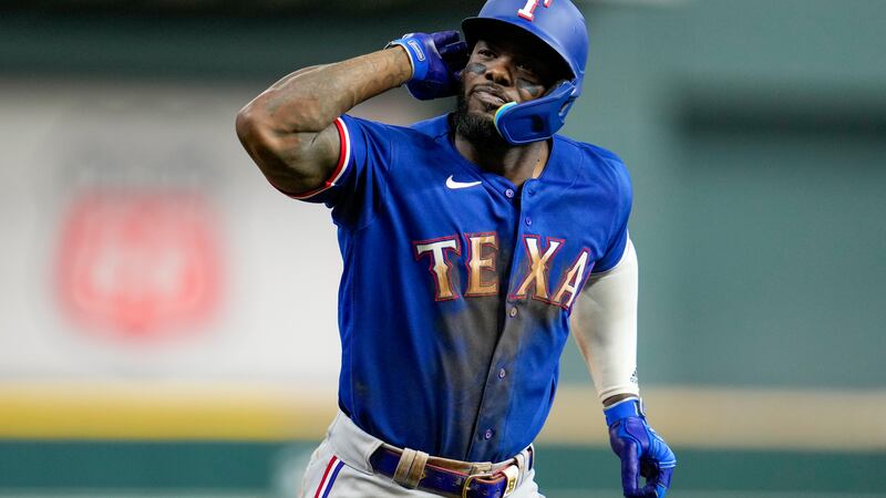 Texas Rangers' Adolis Garcia reacts after hitting a home run during the eighth inning of Game...