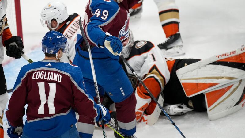 Colorado Avalanche defenseman Samuel Girard, center, celebrates after scoring a goal with...