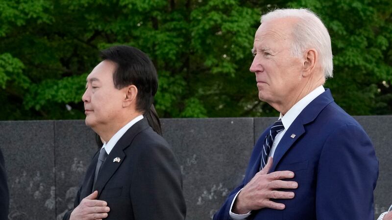 President Joe Biden and South Korea's President Yoon Suk Yeol pause after laying a wreath as...