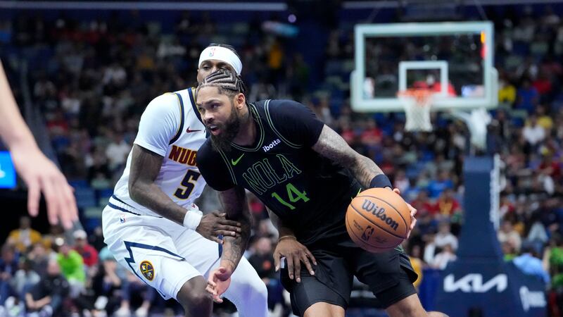 New Orleans Pelicans forward Brandon Ingram (14) drives to the basket against Denver Nuggets...