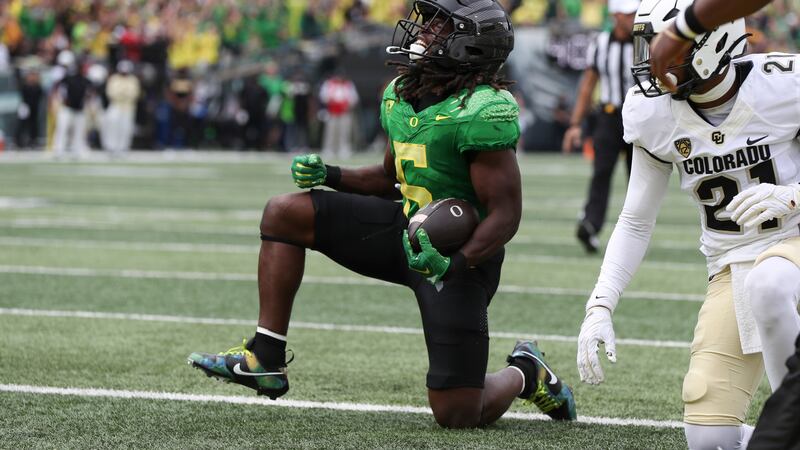 Oregon running back Noah Whittington (6) celebrates after scoring a touchdown against Colorado...