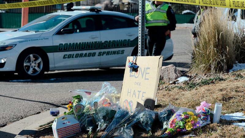 Flowers and a sign reading "love over hate" lay near a gay nightclub in Colorado Springs,...