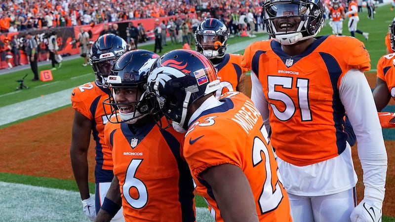 Denver Broncos safety P.J. Locke (6) is congratulated by teammates after intercepting a pass...